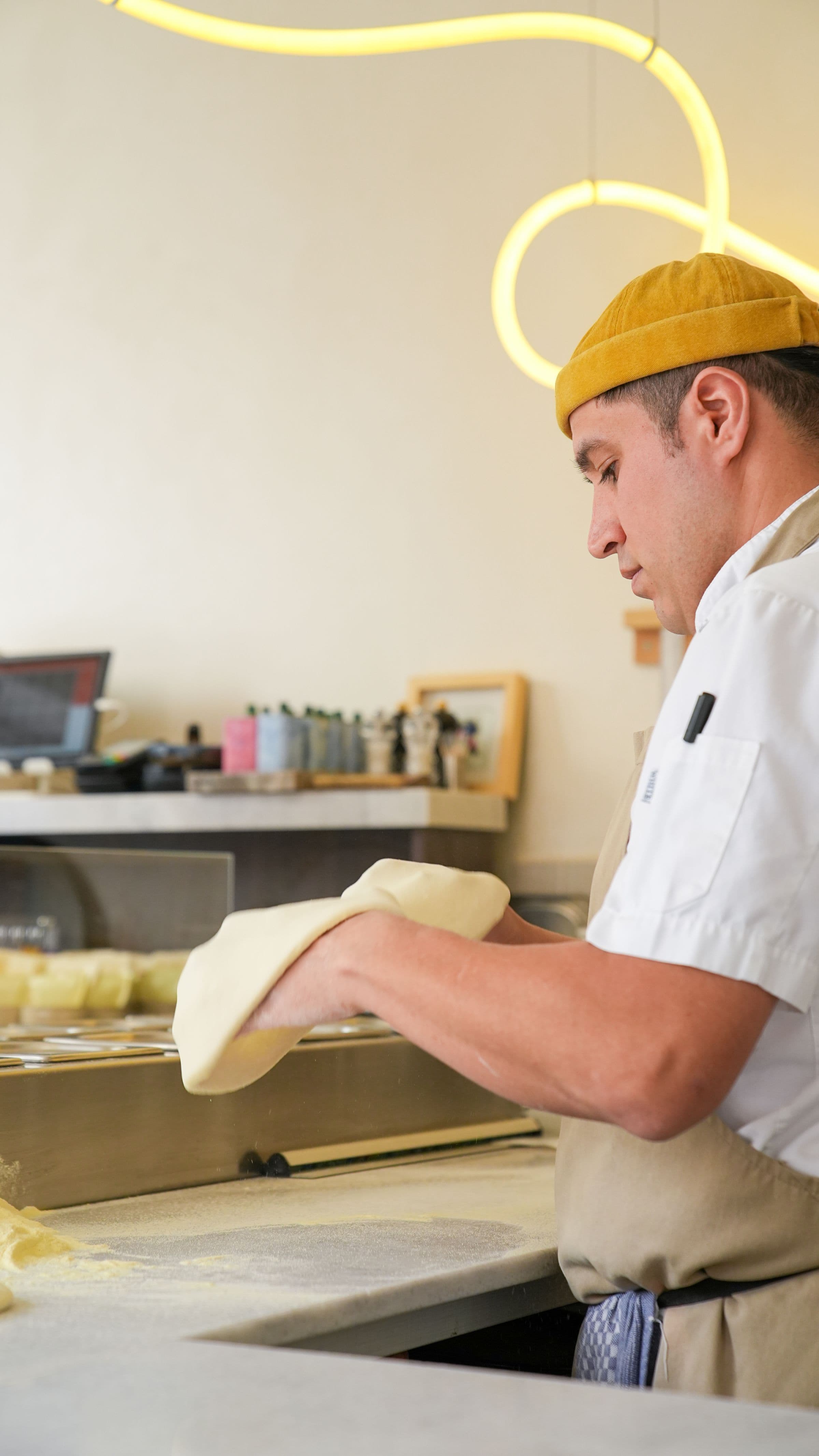 Artisan baker preparing dough at a bakery worktop