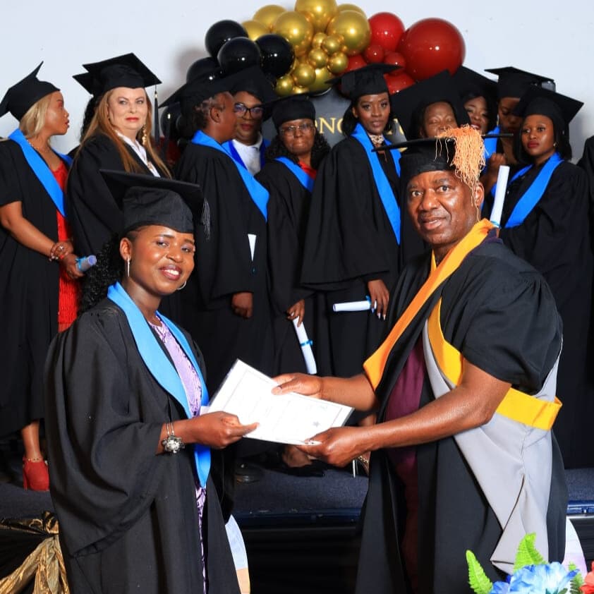 A GE College graduate receiving her certificate on stage